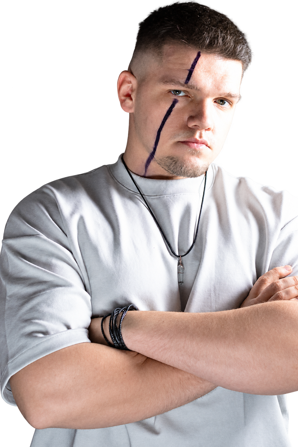KNNY in a light-grey T-shirt with folded arms and his signature face marking